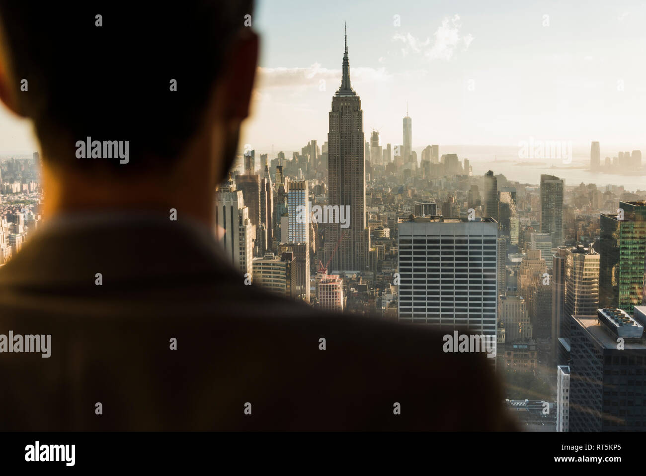 USA, New York City, man looking on cityscape on Rockefeller Center