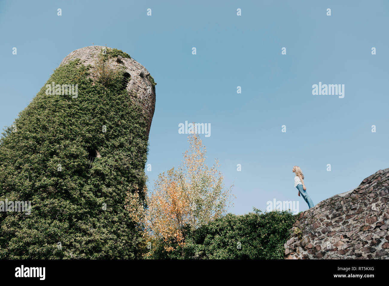 Germany, Black Forest, Sitzenkirch, young woman visiting Sausenburg Castle Stock Photo