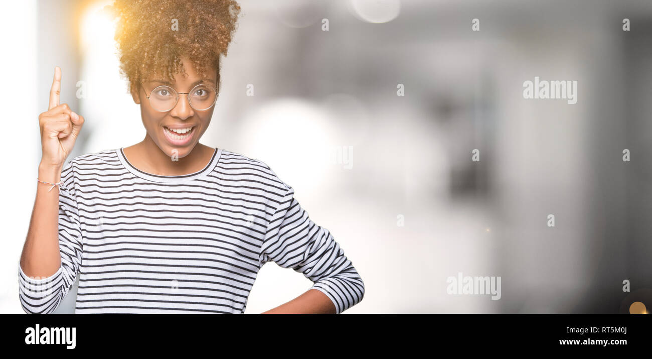 Beautiful young african american woman wearing glasses over isolated ...