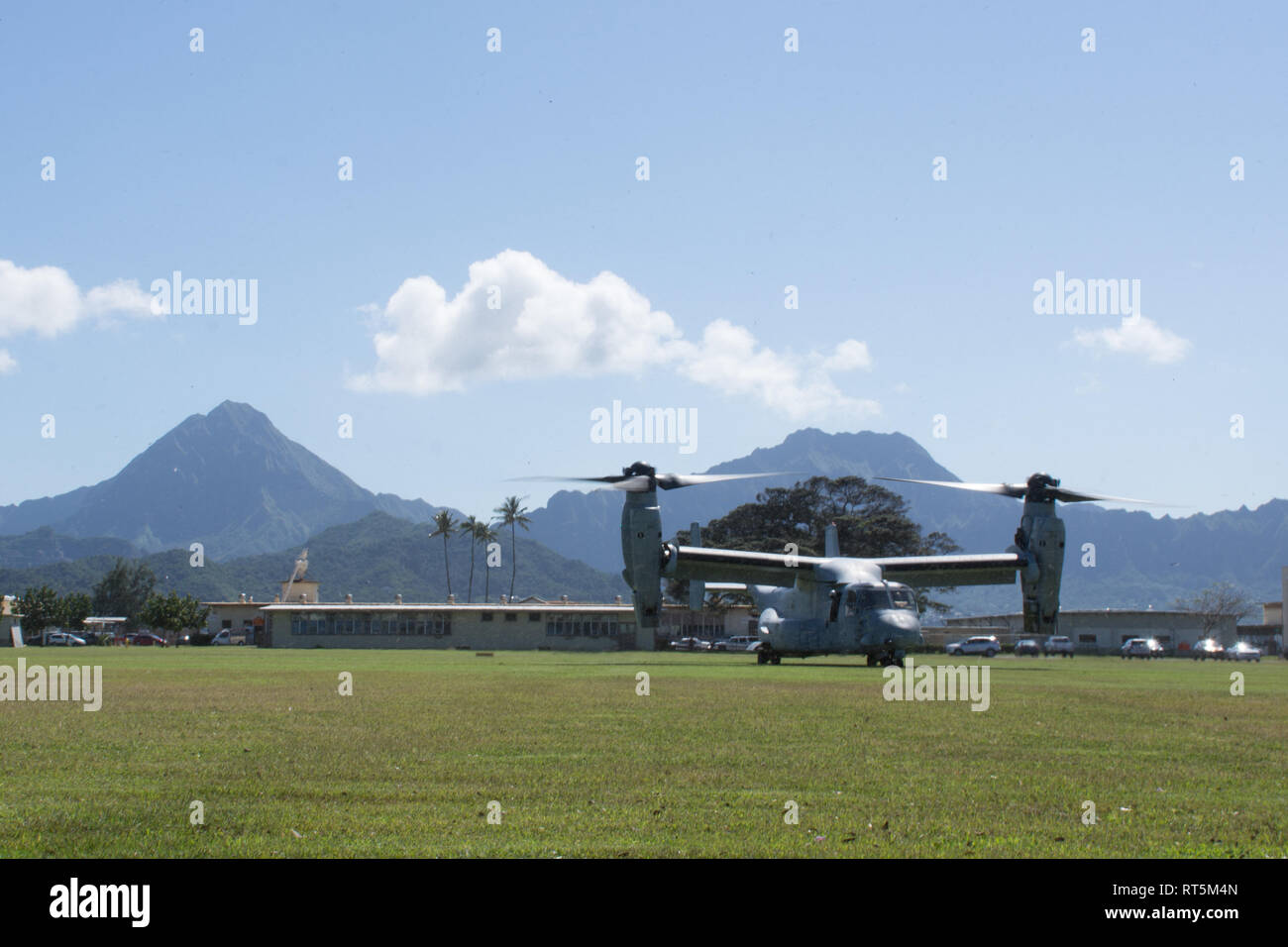 An MV-22B Osprey tiltrotor helicopter with the Marine Medium Tiltrotor Squadron 268 lands at Landing Zone 216 to recover a simulated downed aircraft pilot during a combat search and rescue training at Marine Corps Base Hawaii, Feb. 26, 2019. The CSAR training enhanced joint service crisis response capabilities to include locating, communicating, providing medical attention and recovering the isolated member. (U.S. Air Force photo by Senior Airman Missy Sterling) Stock Photo
