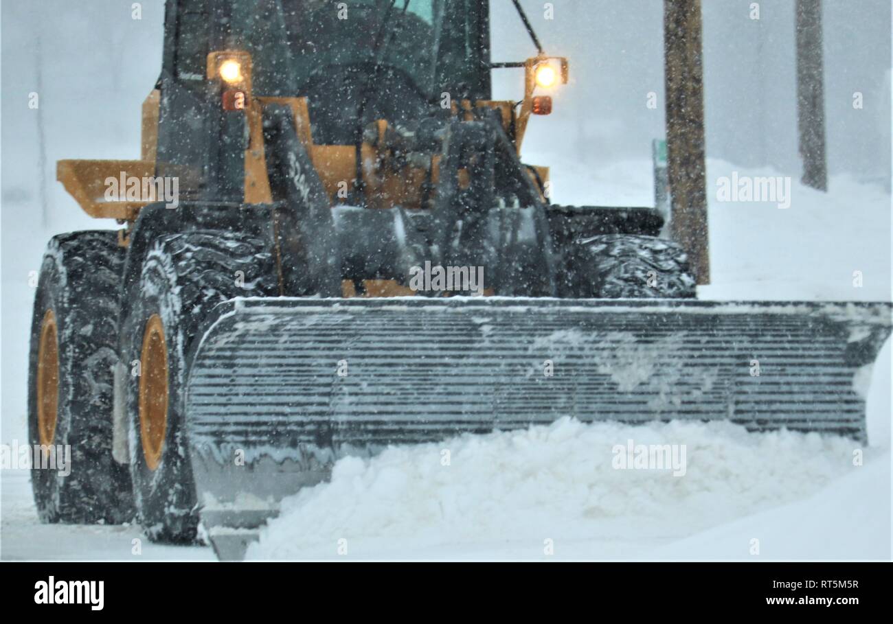 An equipment operator with the Fort McCoy snow removal contractor, Kaiyuh Services LLC of Anchorage, Alaska, clears snow Feb. 20, 2019, at Fort McCoy, Wis. Winter in Wisconsin can provide all kinds of bad weather, including freezing rain, snow, or sleet at any time or even all in one day. When that happens, the Fort McCoy snow-removal team plows through whatever Mother Nature dishes out. The team includes as well as Directorate of Public Works personnel. The team helps keep more than 400 miles of roads, sidewalks, and parking areas clear so the Fort McCoy workforce can operate safely. (U.S. Ar Stock Photo