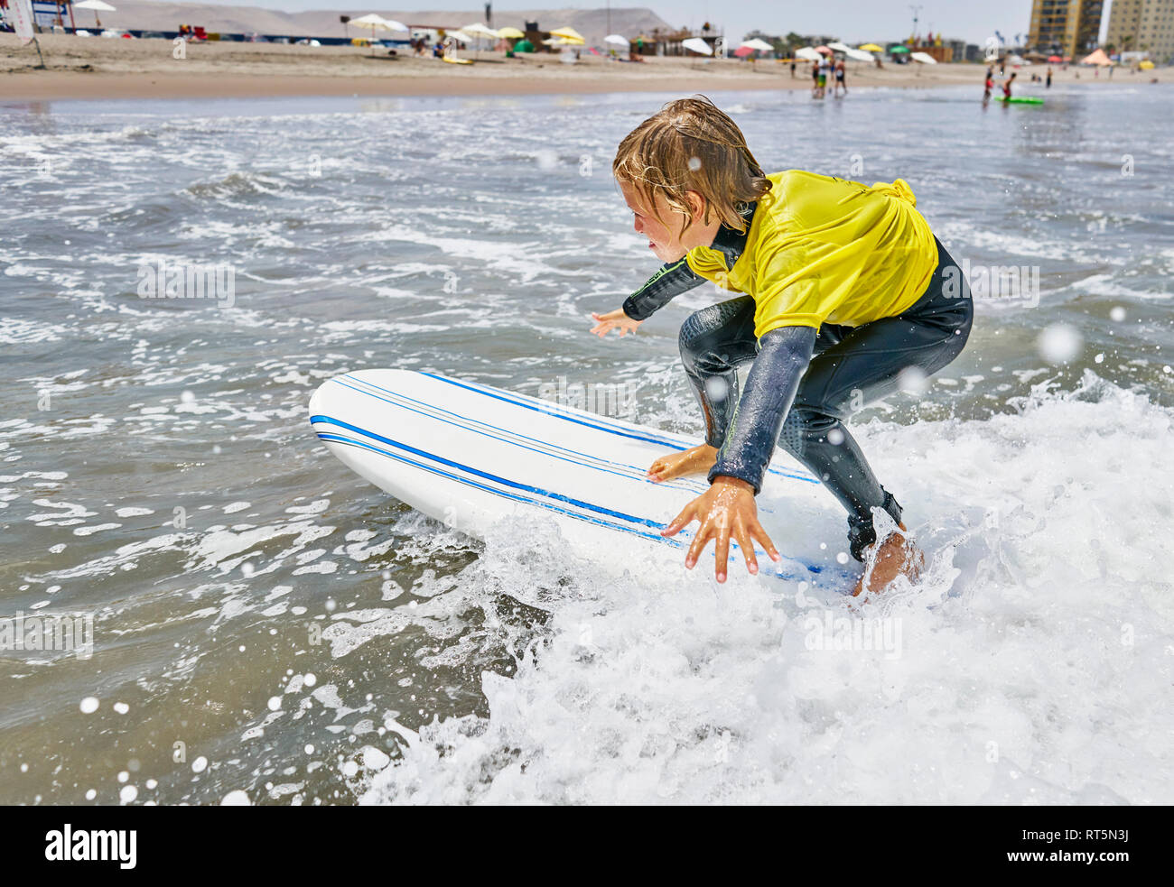Chile, Arica, boy surfing in the sea Stock Photo