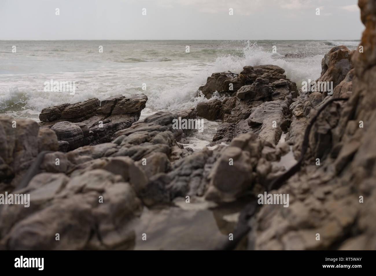Sea waves splashing on the rock Stock Photo