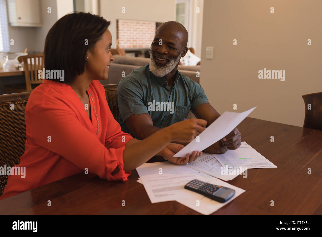 Senior couple discussing over invoices at home Stock Photo