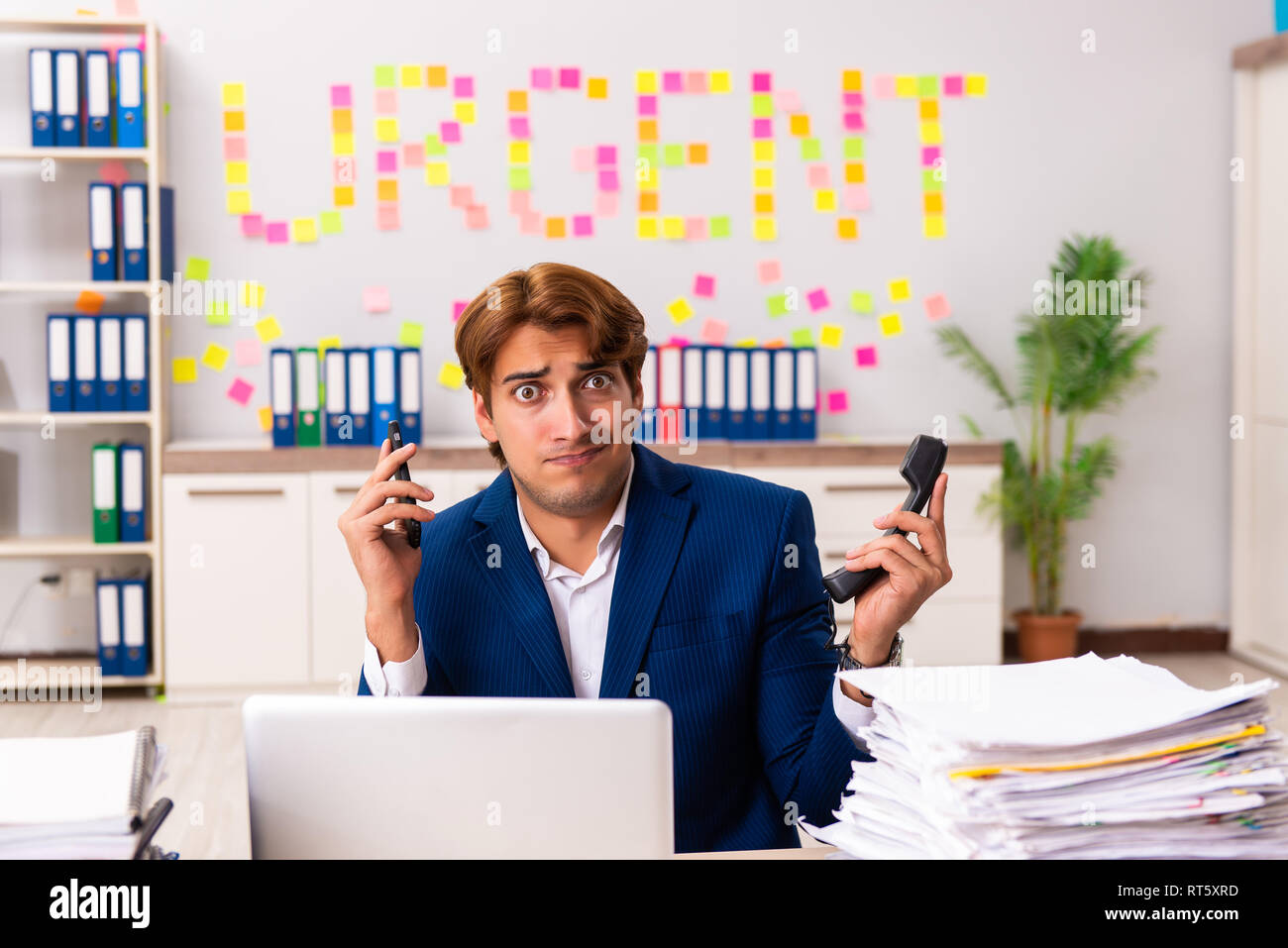 Young employee suffering from excessive work Stock Photo