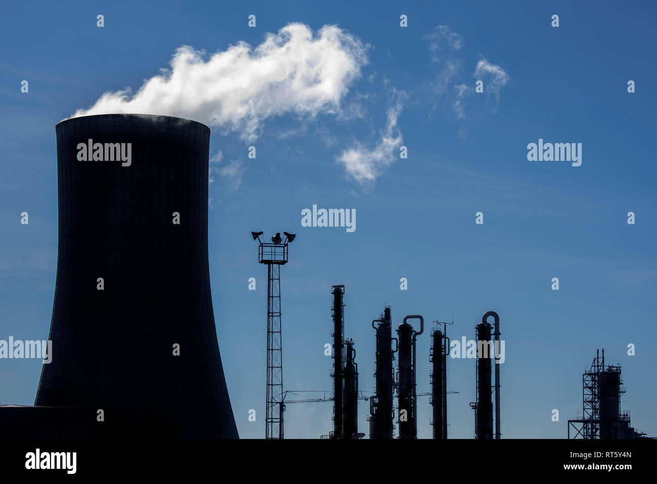 Silhouette of industrial estate showing cooling tower of the BASF chemical production site in the port of Antwerp, Belgium Stock Photo