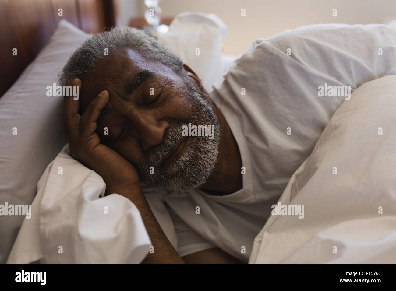 Senior man sleeping in bedroom at home Stock Photo - Alamy