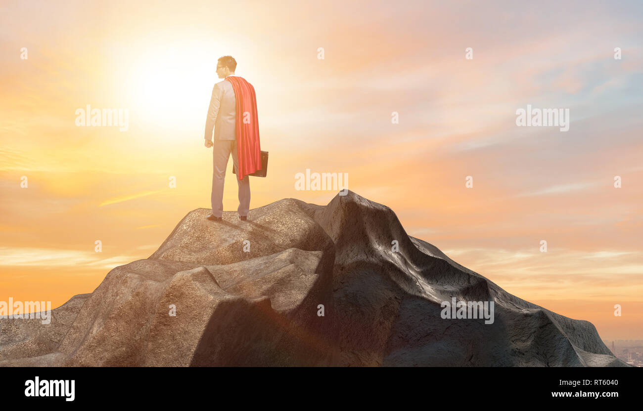 Superhero businessman on top of mountain Stock Photo - Alamy