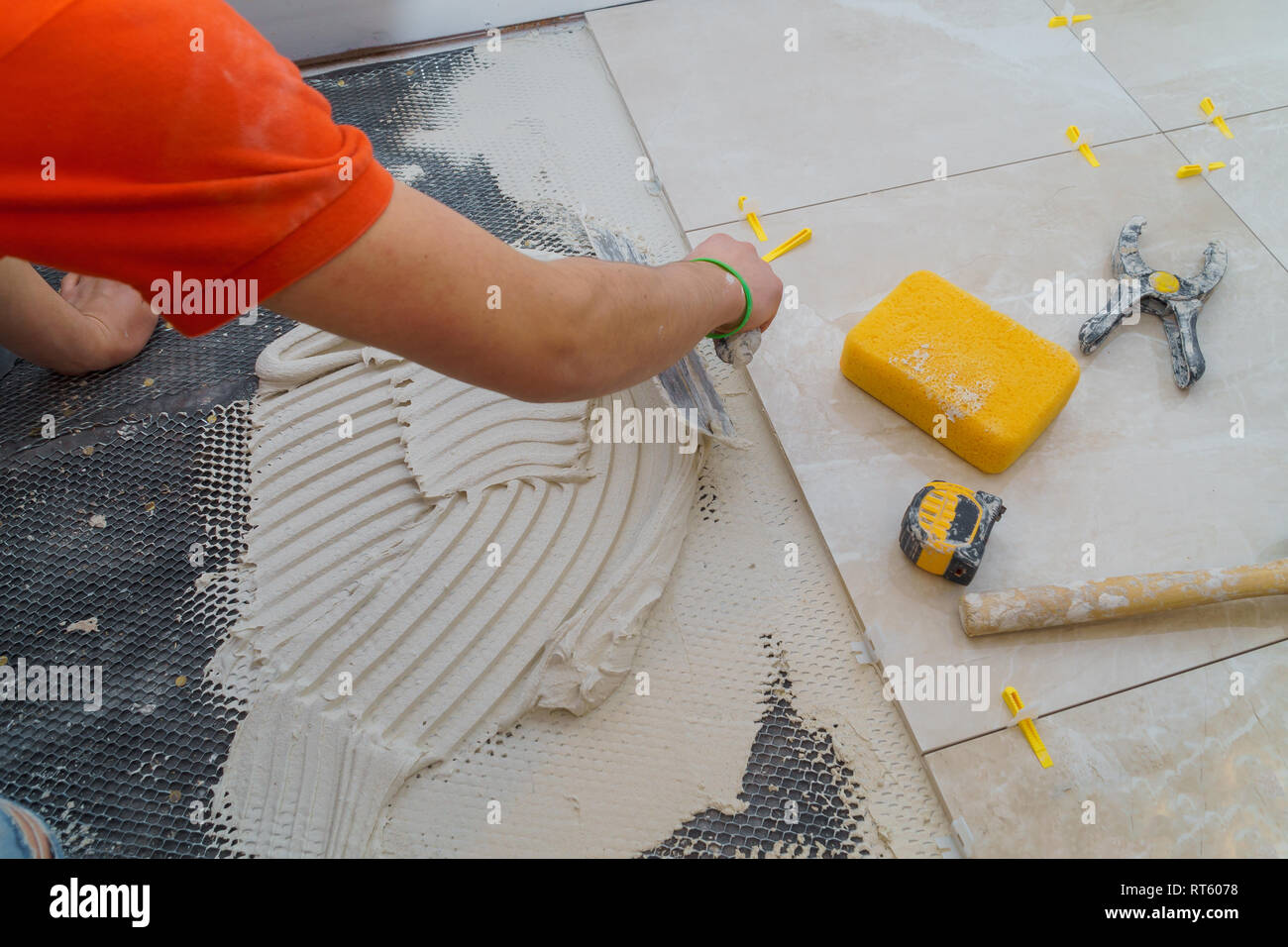 Applying new tiles on bathroom floor tile installation for house