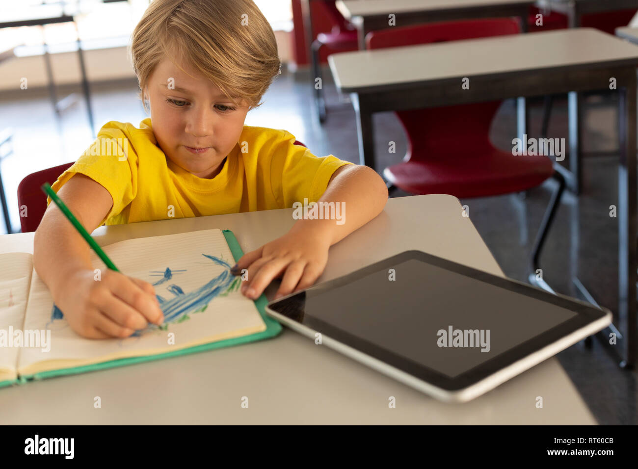 Boy sitting desk coloring hires stock photography and images Alamy