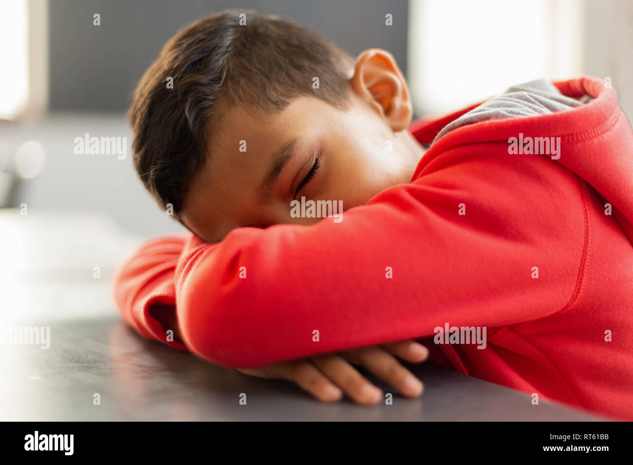 Schoolboy sleeping at desk in a classroom Stock Photo - Alamy