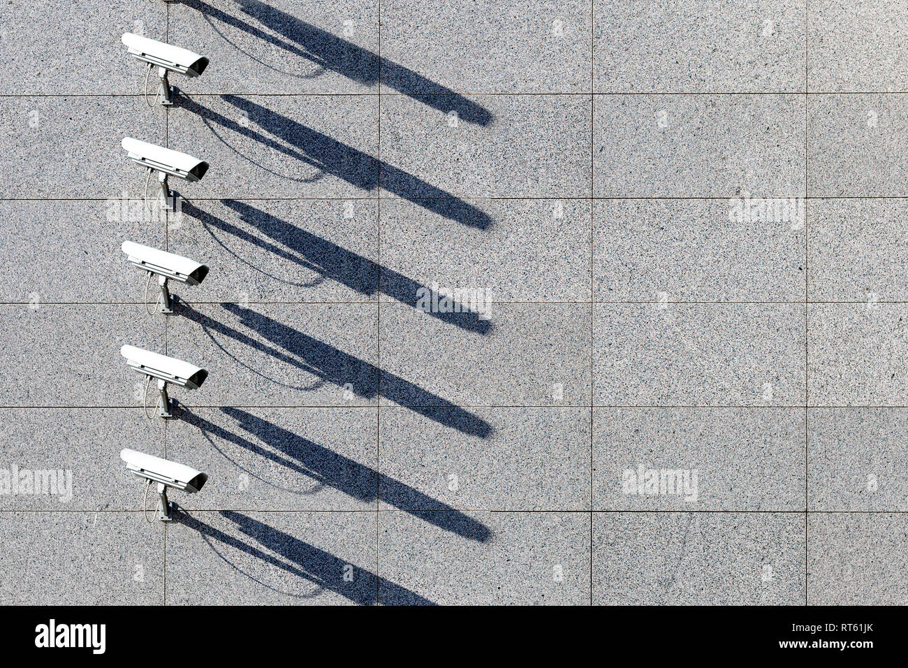 security video surveillance cameras in a row at marble wall background