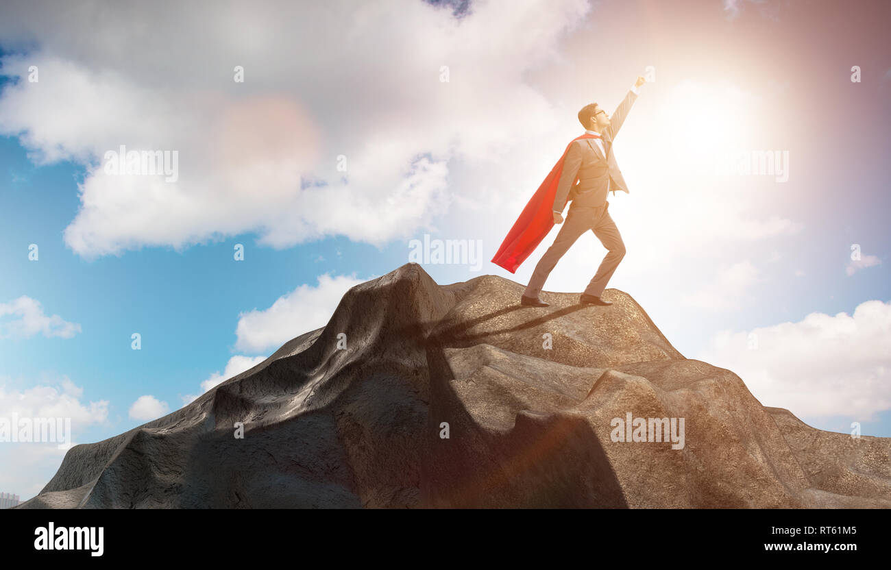 Superhero businessman on top of mountain Stock Photo - Alamy