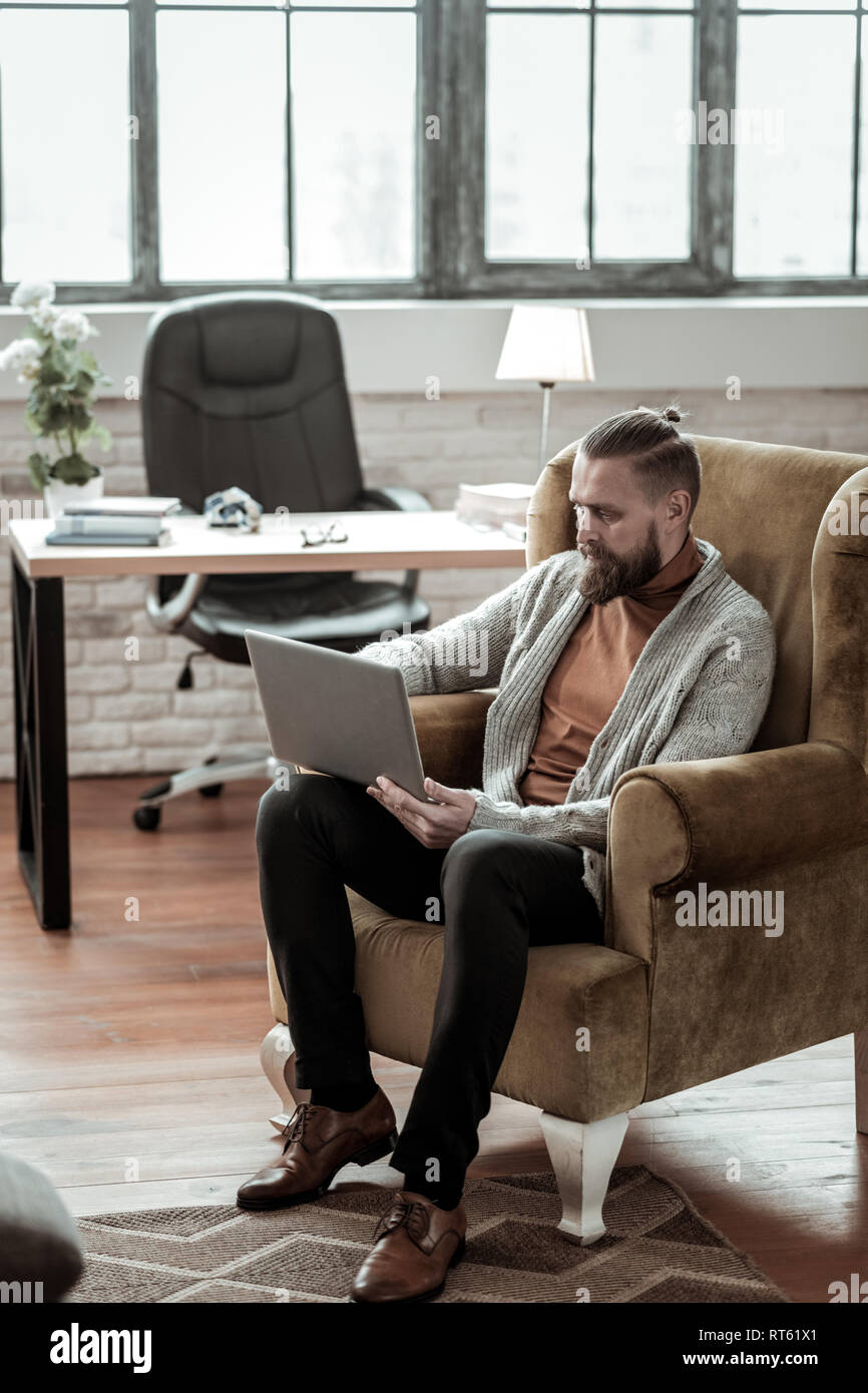 Smart psychologist. Experienced smart psychologist sitting in his room