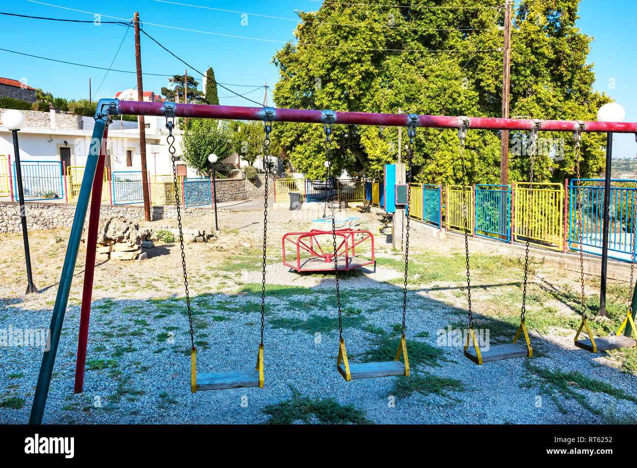 Old empty playground in Greek village on Island of Rhodes (Rhodes, Greece) Stock Photo