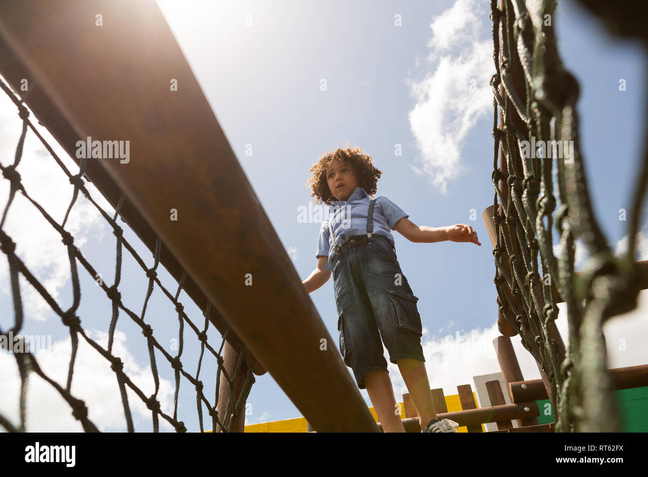 Schoolgirl walking on net bridge in the school playground Stock Photo ...