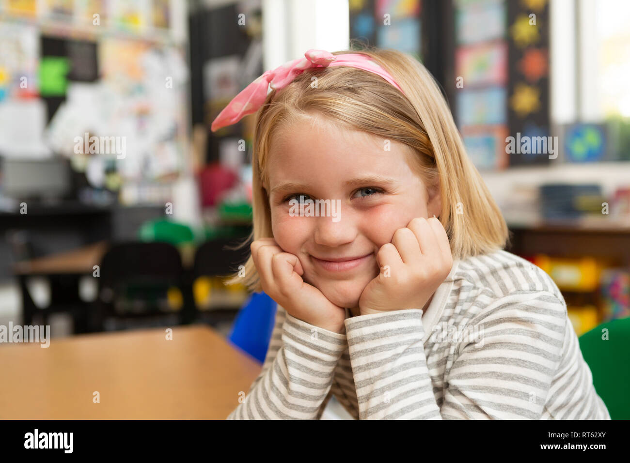 Schoolgirl sitting at desk in the classroom at school Stock Photo - Alamy