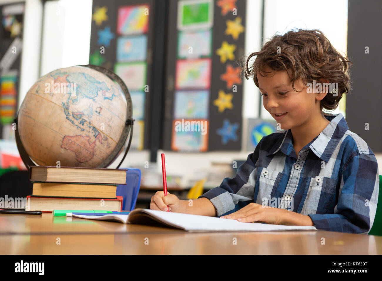 Schoolboy studying at desk in the classroom Stock Photo - Alamy