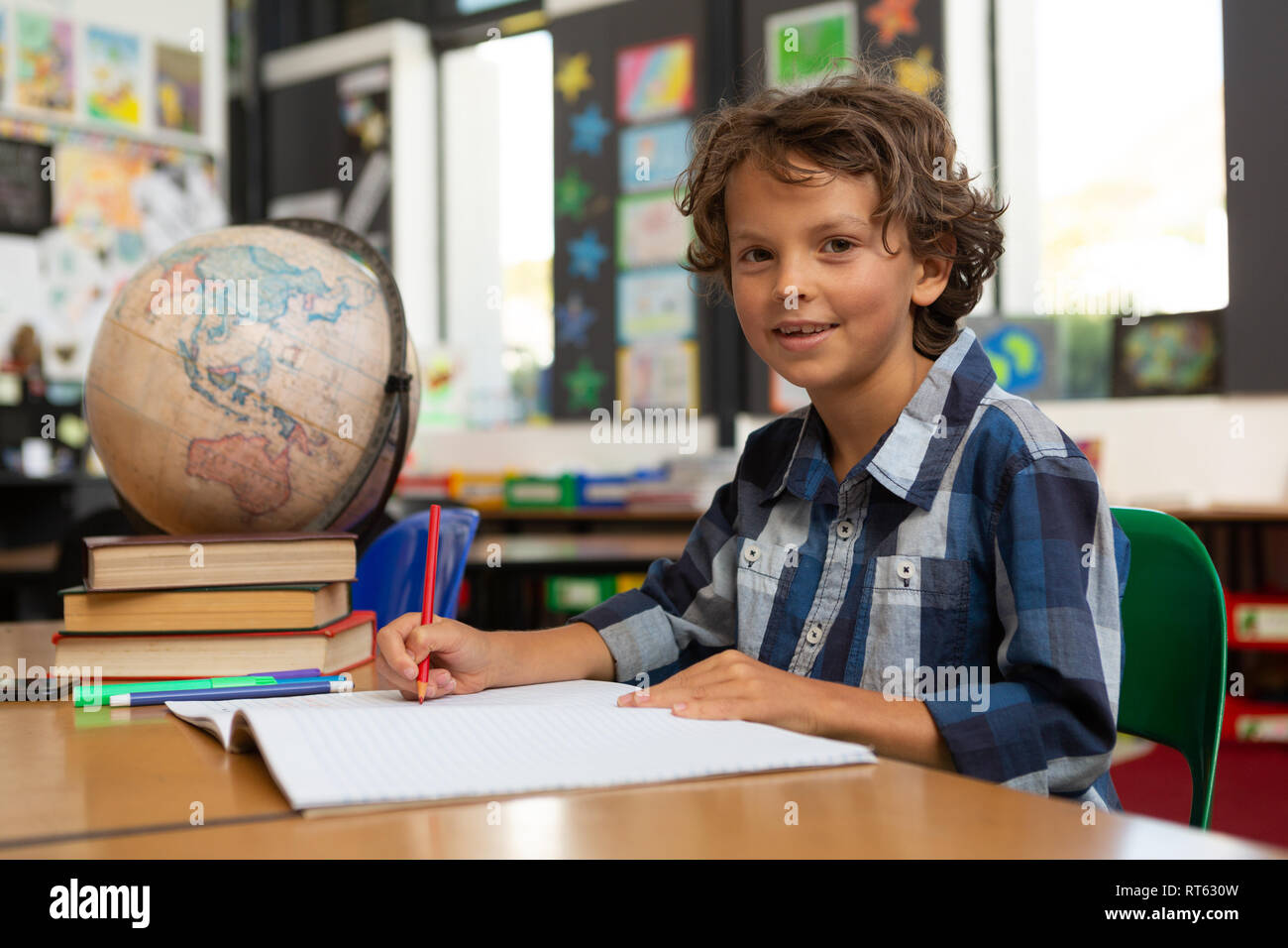 Schoolboy studying at desk in the classroom Stock Photo - Alamy