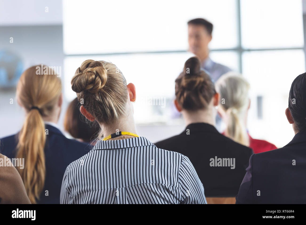 Businesswoman listening to speech at a business seminar Stock Photo