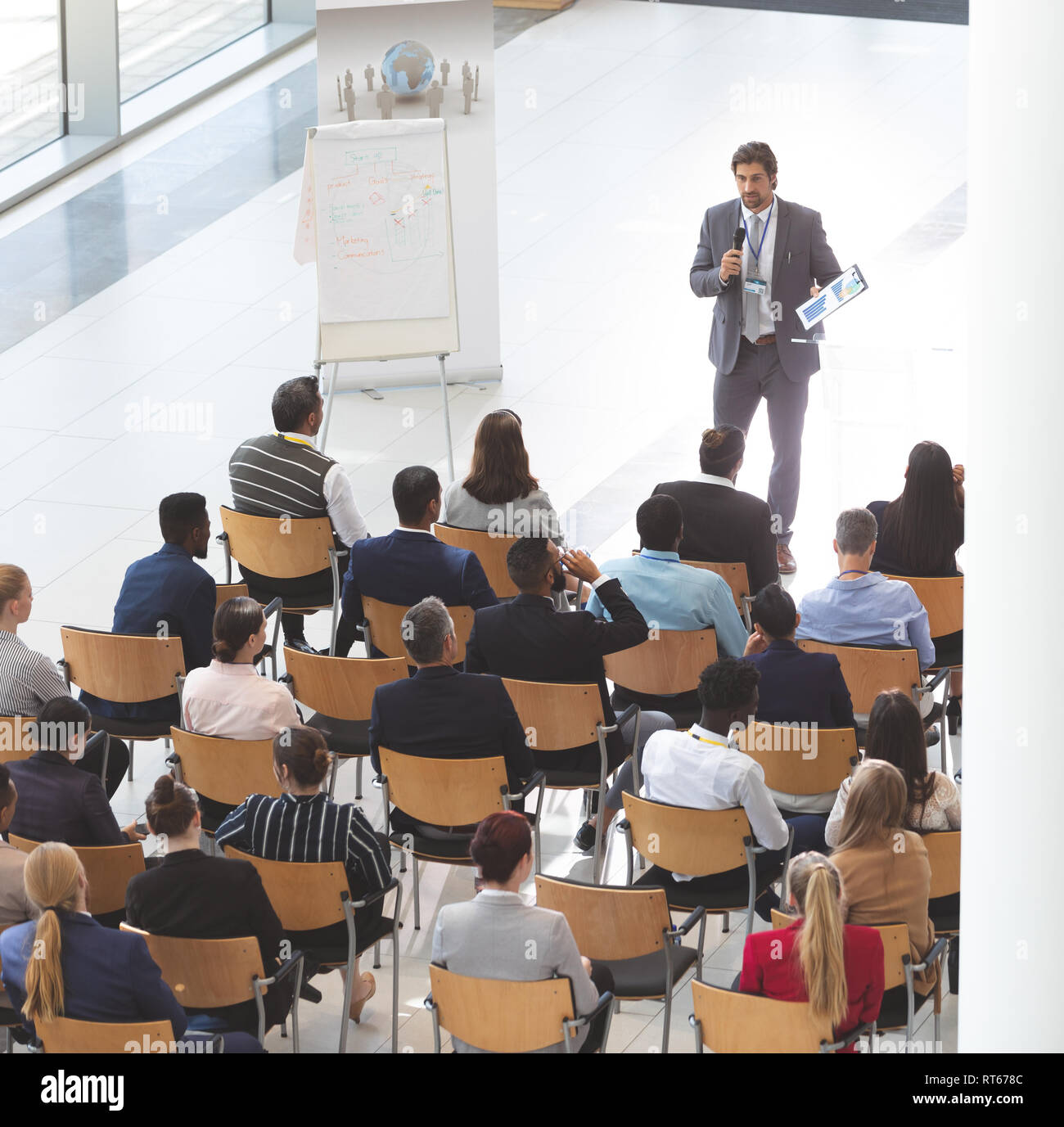 Businessman giving speech at business conference Stock Photo