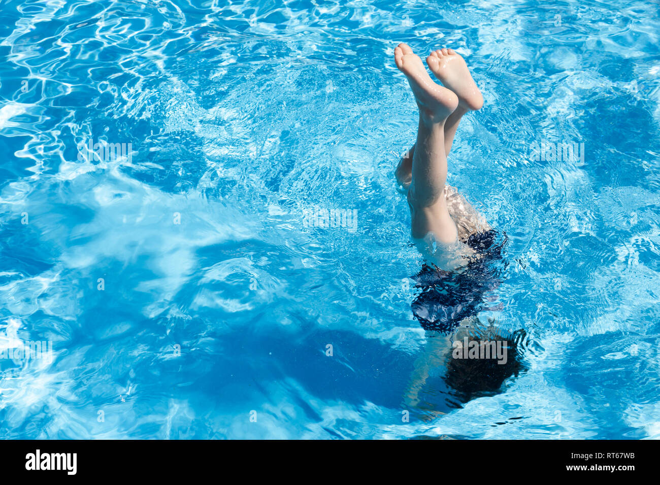Little girl doing handstand in swimming pool Stock Photo Alamy
