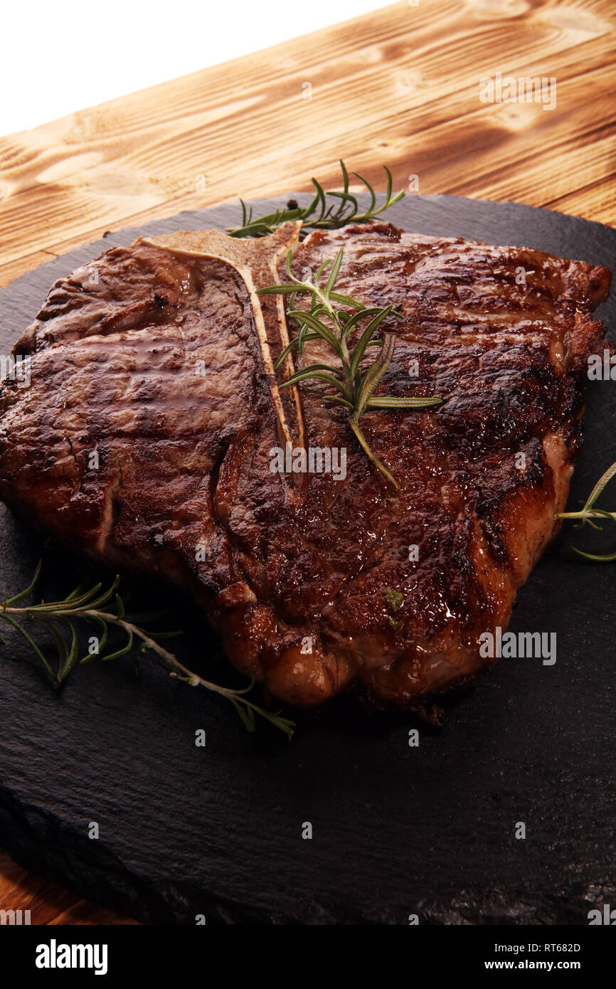 Grilled Tbone steak on stone plate. bbq grill bone steak set Stock