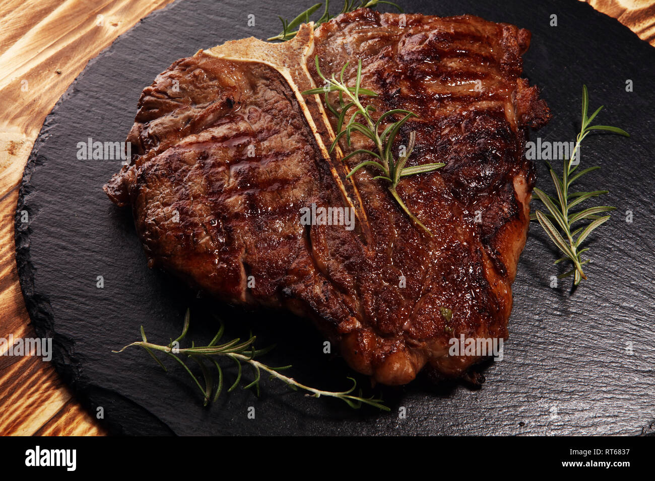 Grilled Tbone steak on stone plate. bbq grill bone steak set Stock