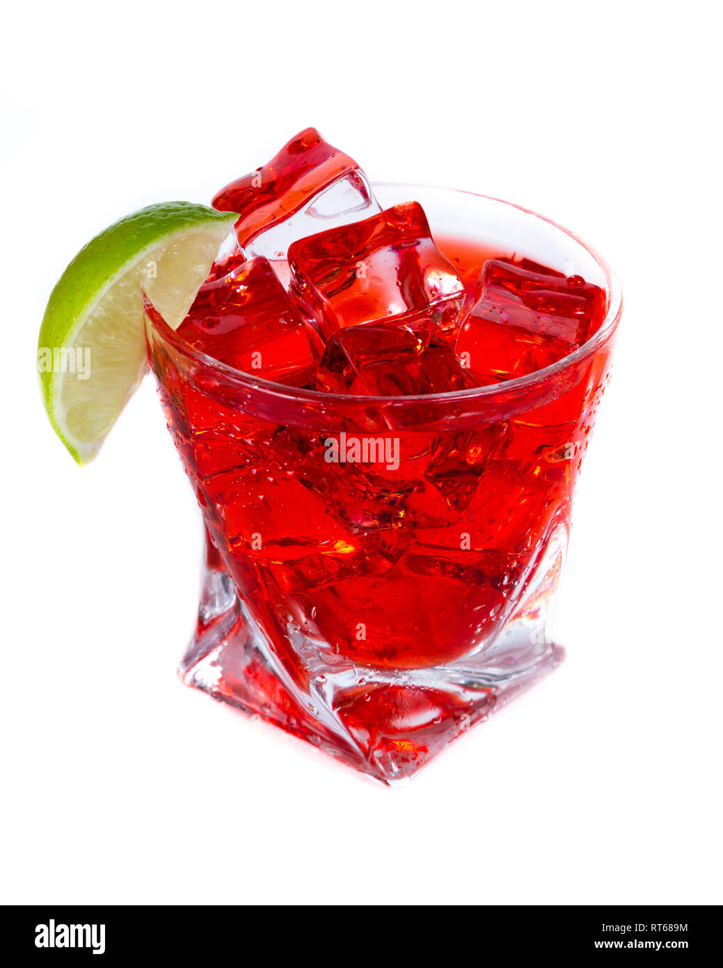 close up of a refreshing classic cocktail with vodka and cranberry juice served on the rocks with a lime wedge garnish isolated on a white background Stock Photo