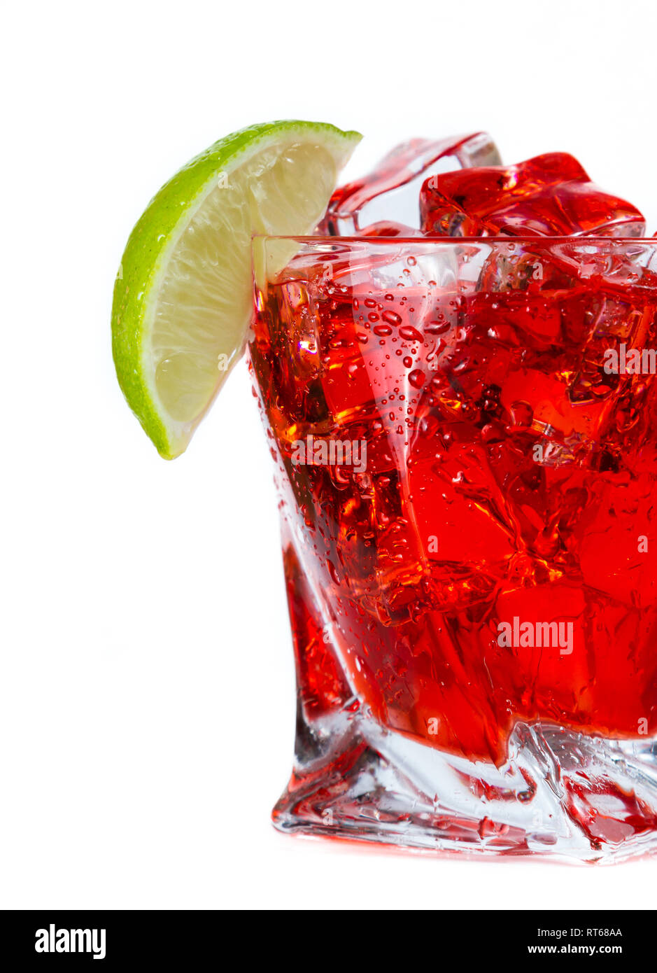 close up of a refreshing classic cocktail with vodka and cranberry juice served on the rocks with a lime wedge garnish isolated on a white background Stock Photo