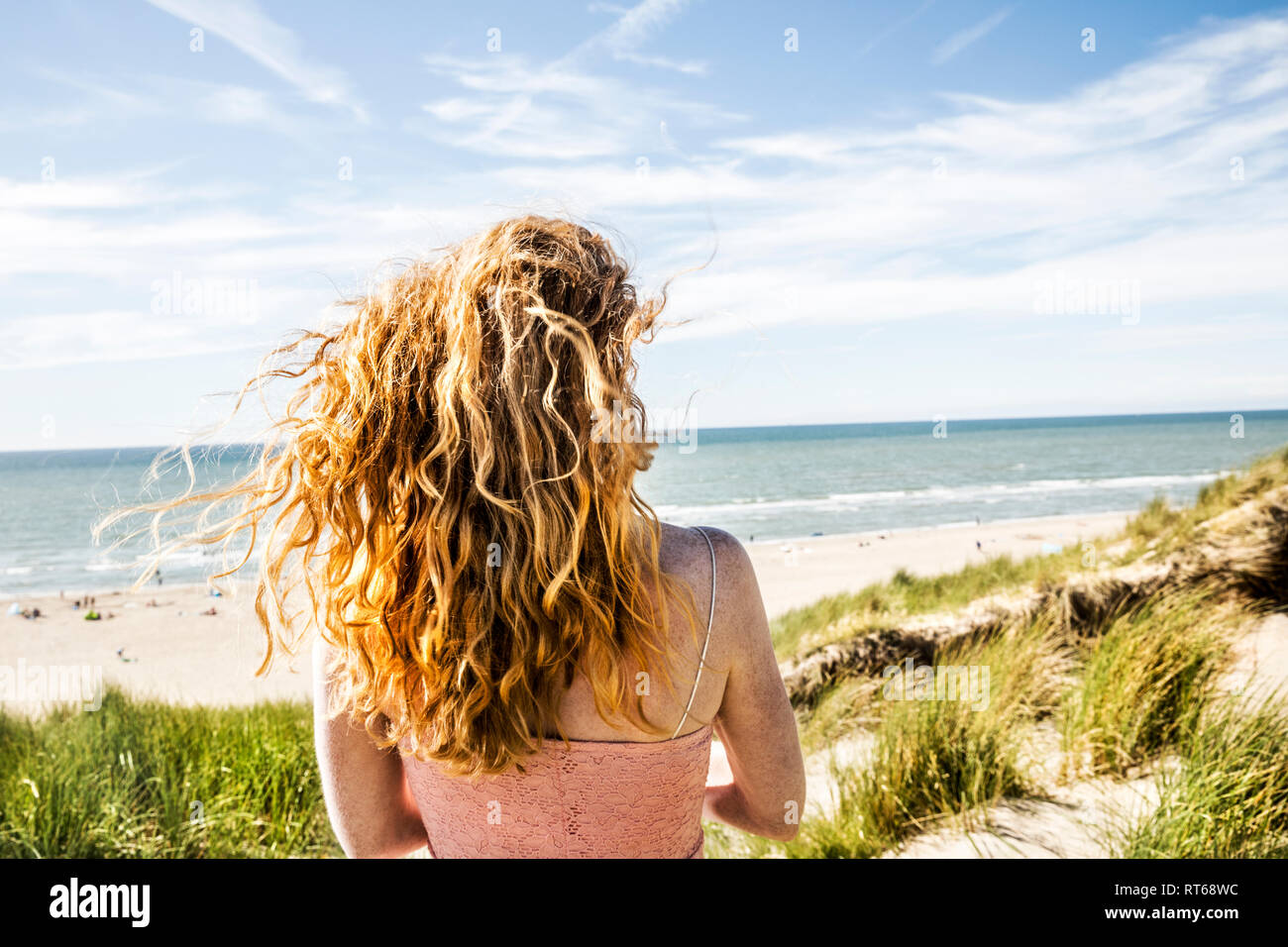 Netherlands, Zandvoort, woman standing in dunes Stock Photo