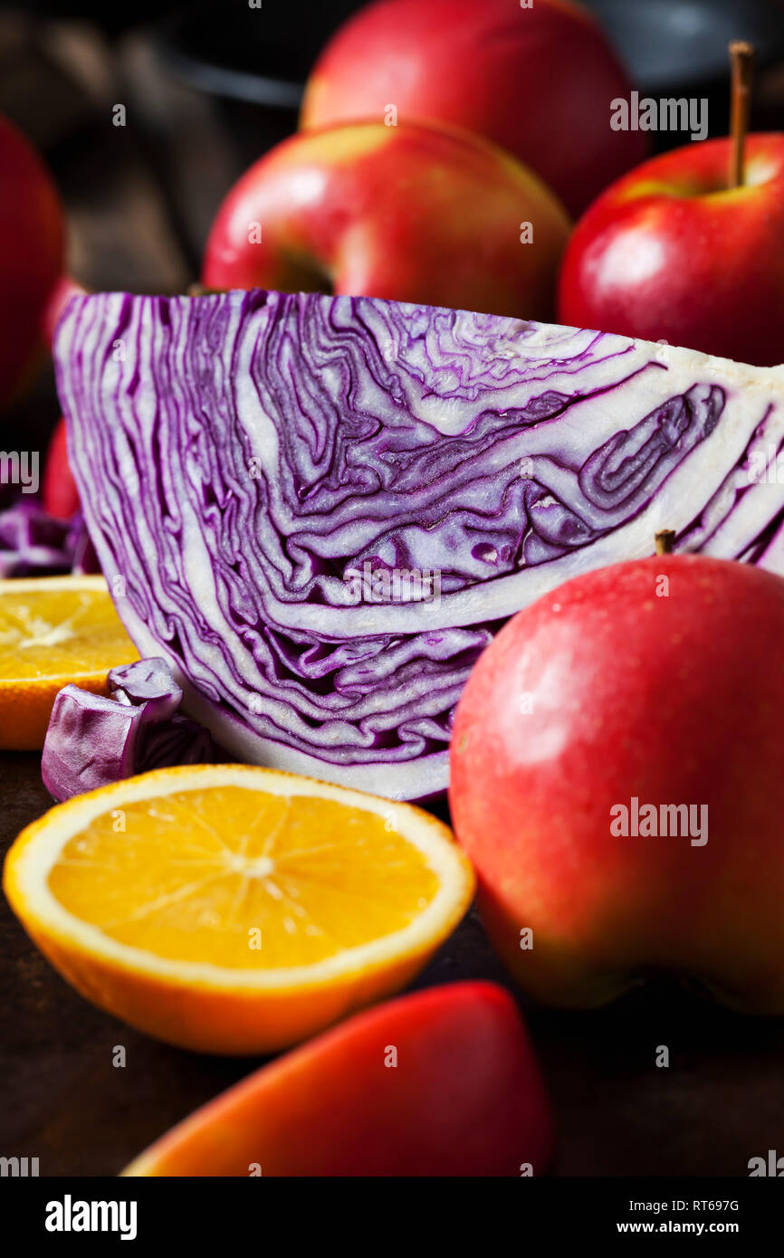 Sliced red cabbage, red apples and sliced orange Stock Photo