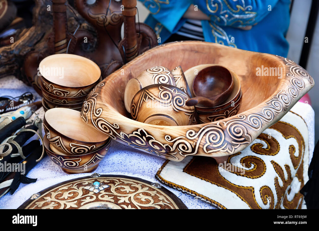 Ethnic wooden cup and bowls with oriental pattern and souvenirs in the market at Nauryz celebration in Almaty, Kazakhstan Stock Photo
