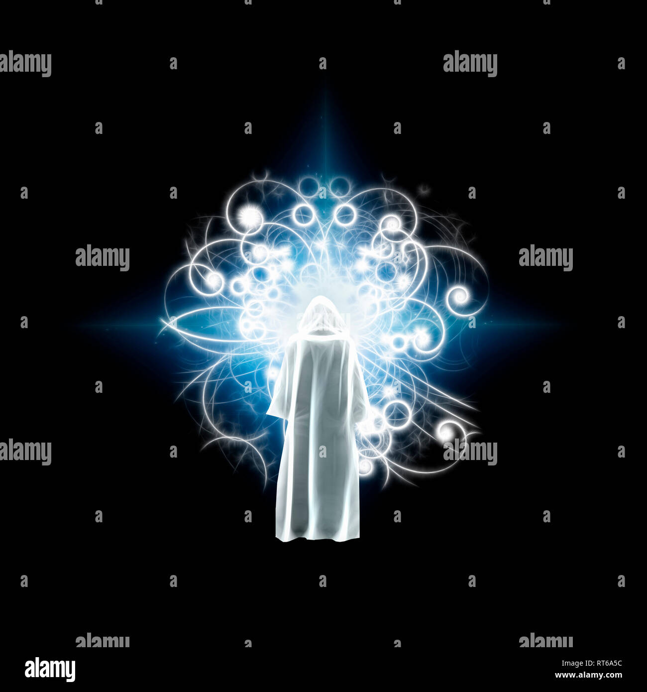 Figure of man in white cloak stands before shining light Stock Photo