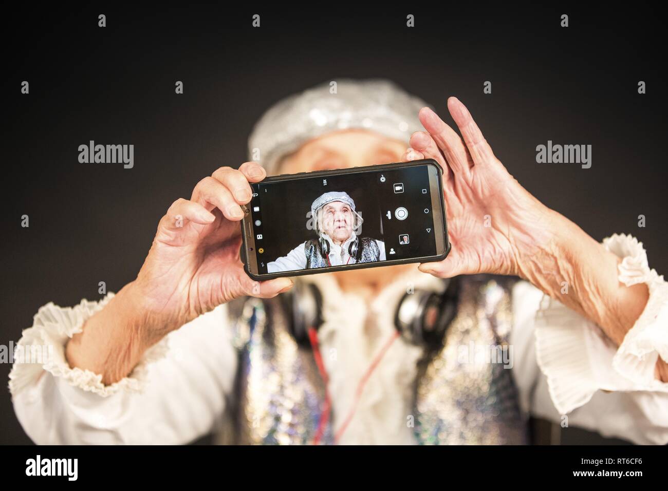 Vintage old woman with a smartphone Stock Photo