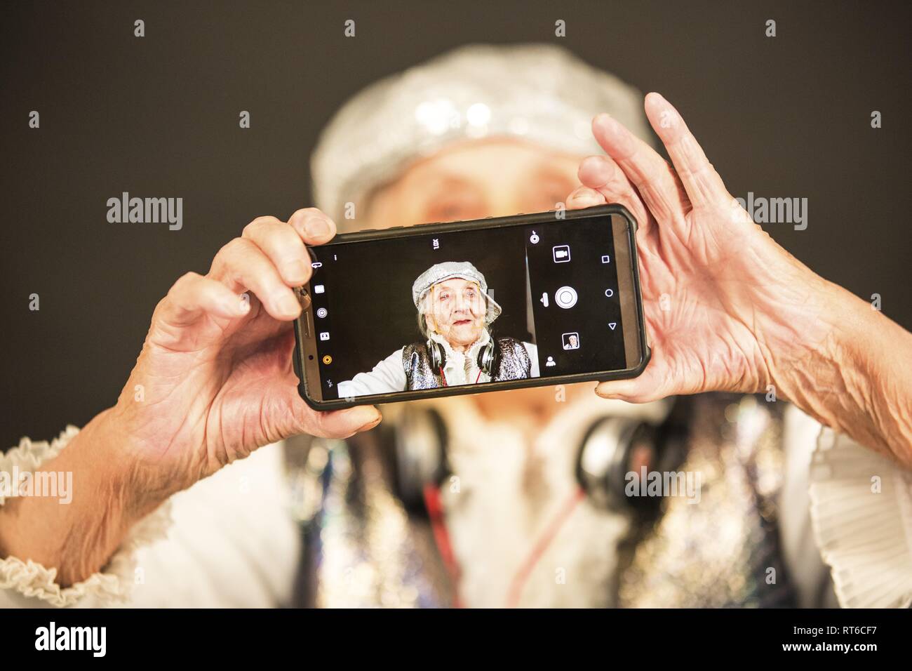 Vintage old woman with a smartphone Stock Photo