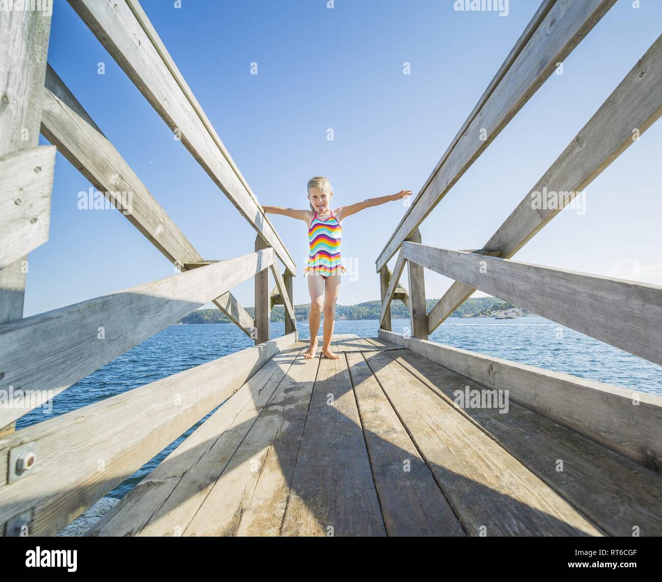 Plank on the water with a blonde girl on it Stock Photo