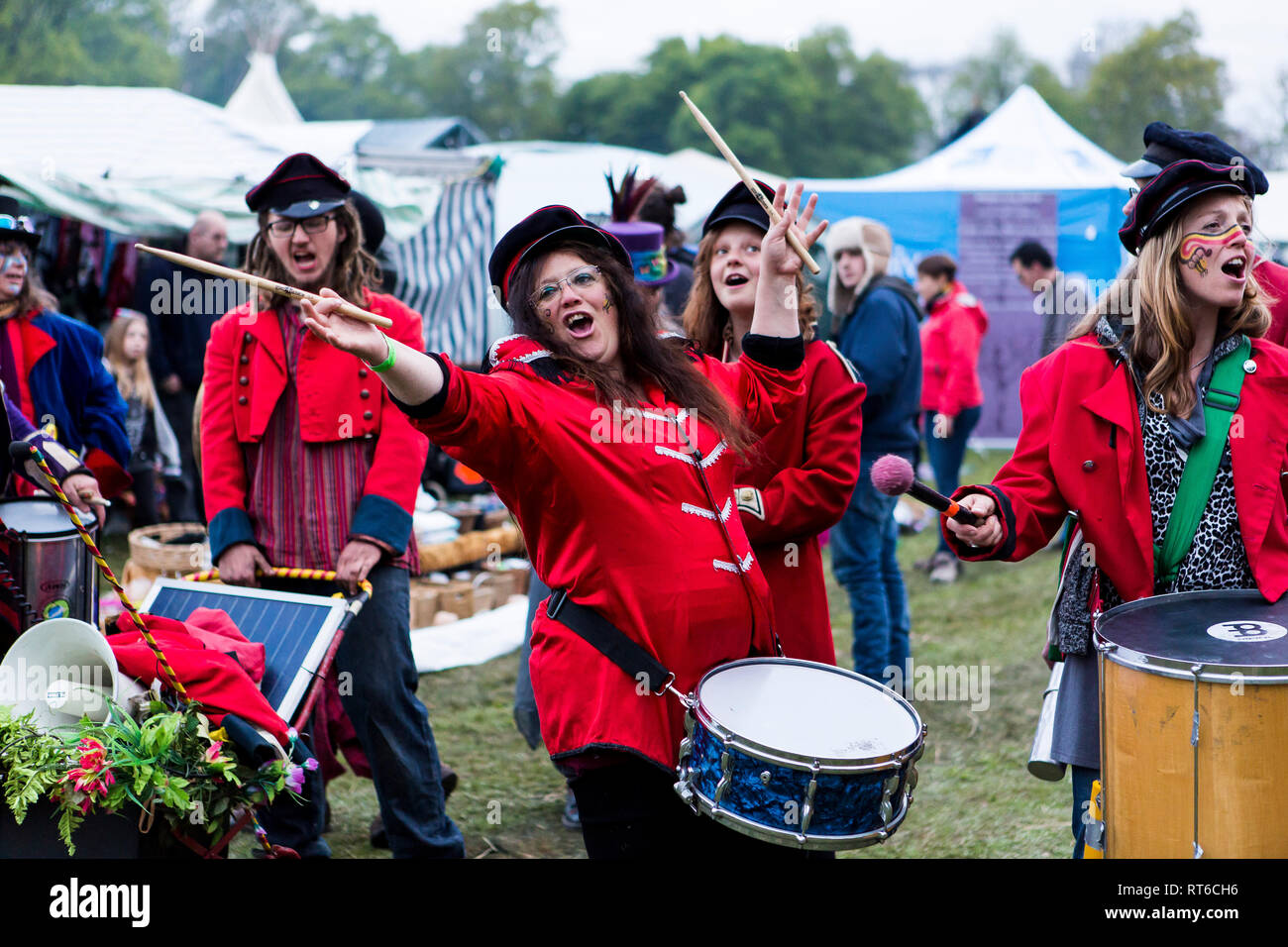 Military style drumming parade with red costumes at Beltane Fire Festival, Sussex, UK Stock Photo