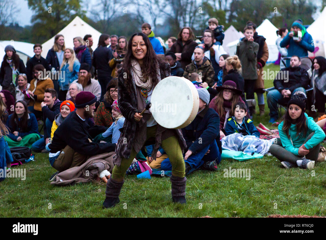 Girl banging a drum at Beltane Fire Festival, Sussex, UK Stock Photo