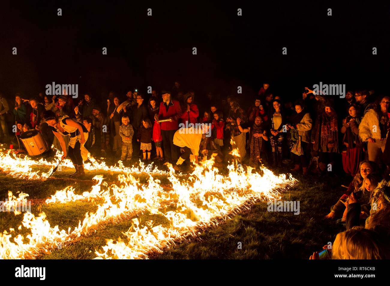 Crowd watching fire show at Beltane Fire Festival, Sussex, UK Stock