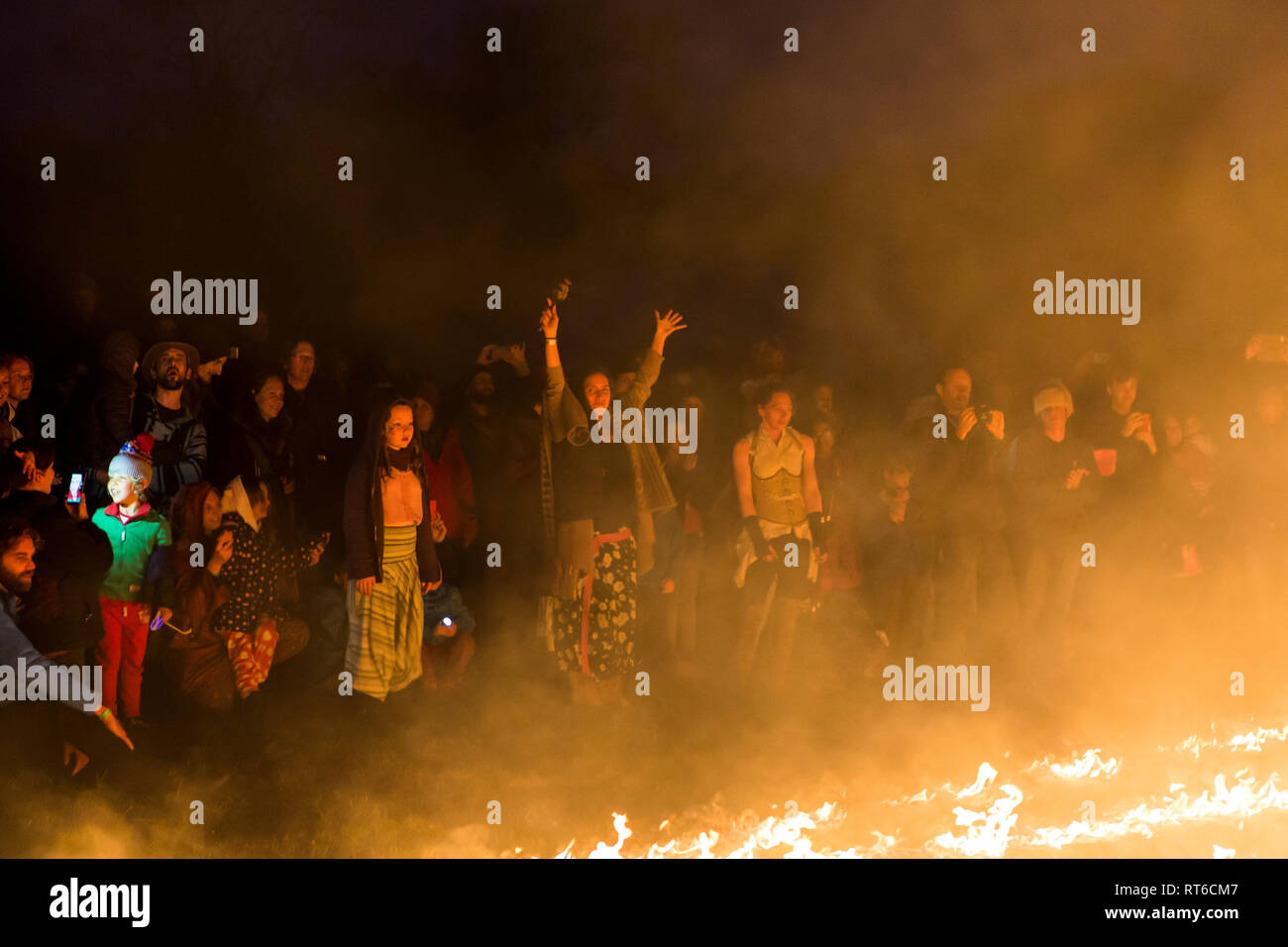 Crowd watching fire show at Beltane Fire Festival, Sussex, UK Stock Photo