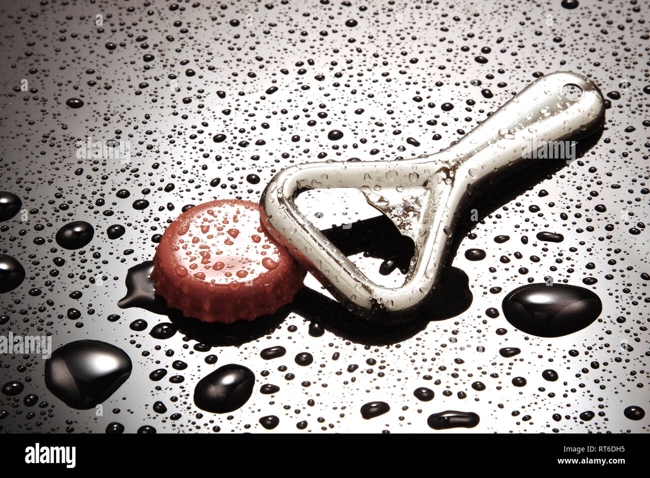 Bottle opener and red bottle cap Stock Photo