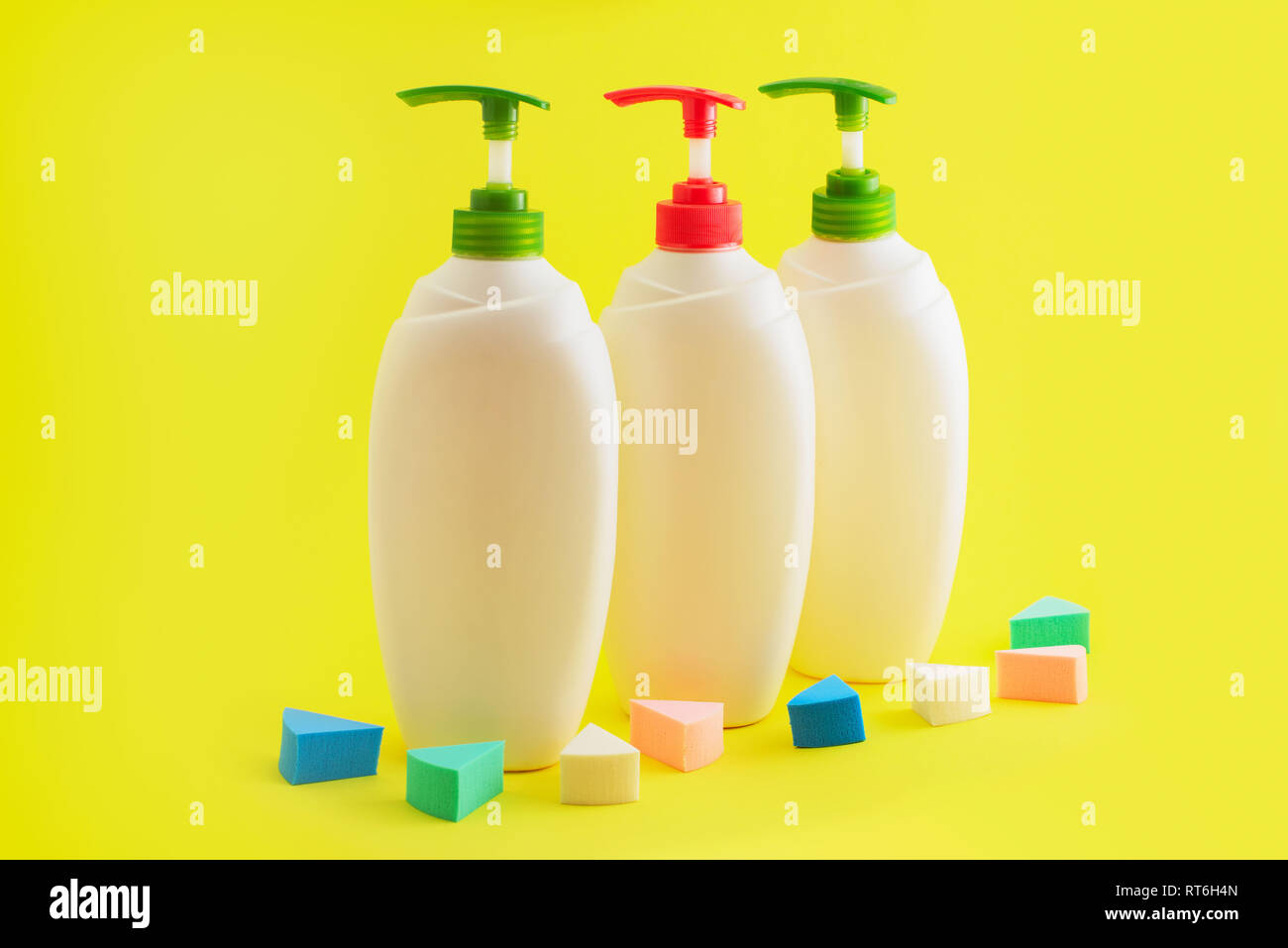 Download Three Plastic Bottles With Dispenser On Yellow Background Cosmetics For Body And Hair Stock Photo Alamy PSD Mockup Templates