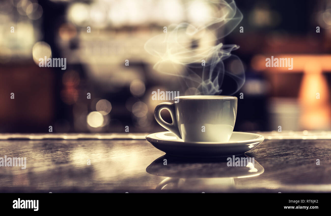 Cup of coffee on bar desk in night club. Stock Photo