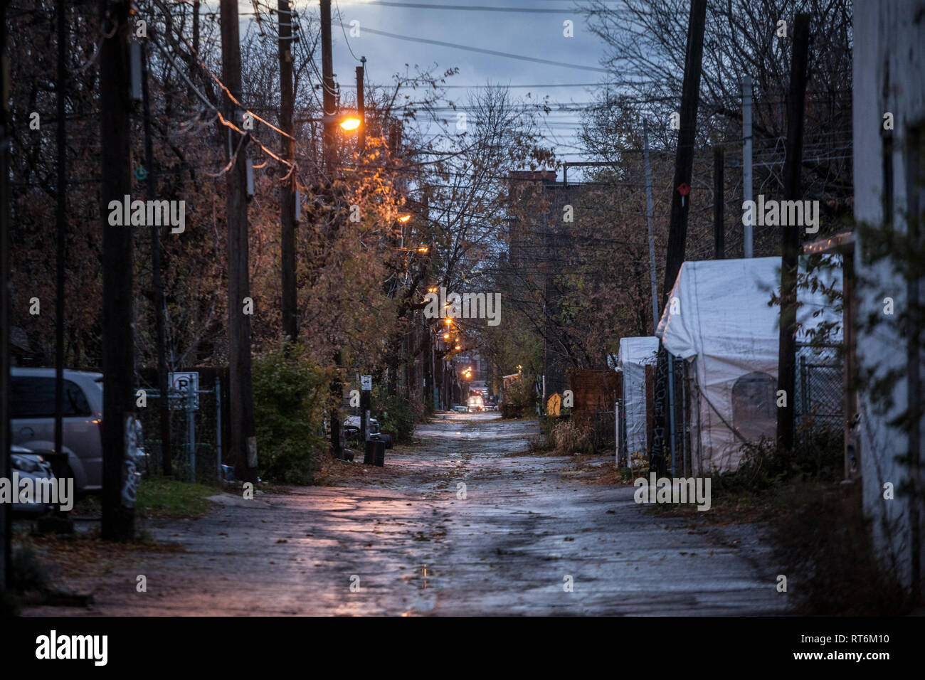 MONTREAL, CANADA - NOVEMBER 3, 2018: Dilapidated typical north American residential street in autumn in Montreal, Quebec, during a rainy evening with  Stock Photo