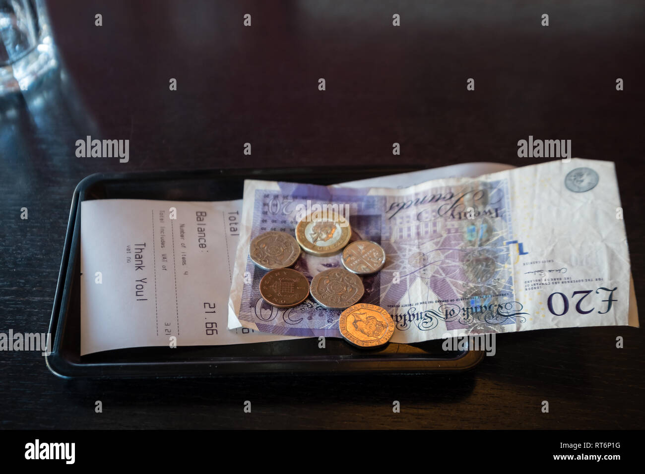 Money left as payment with the bill in a restaurant Stock Photo