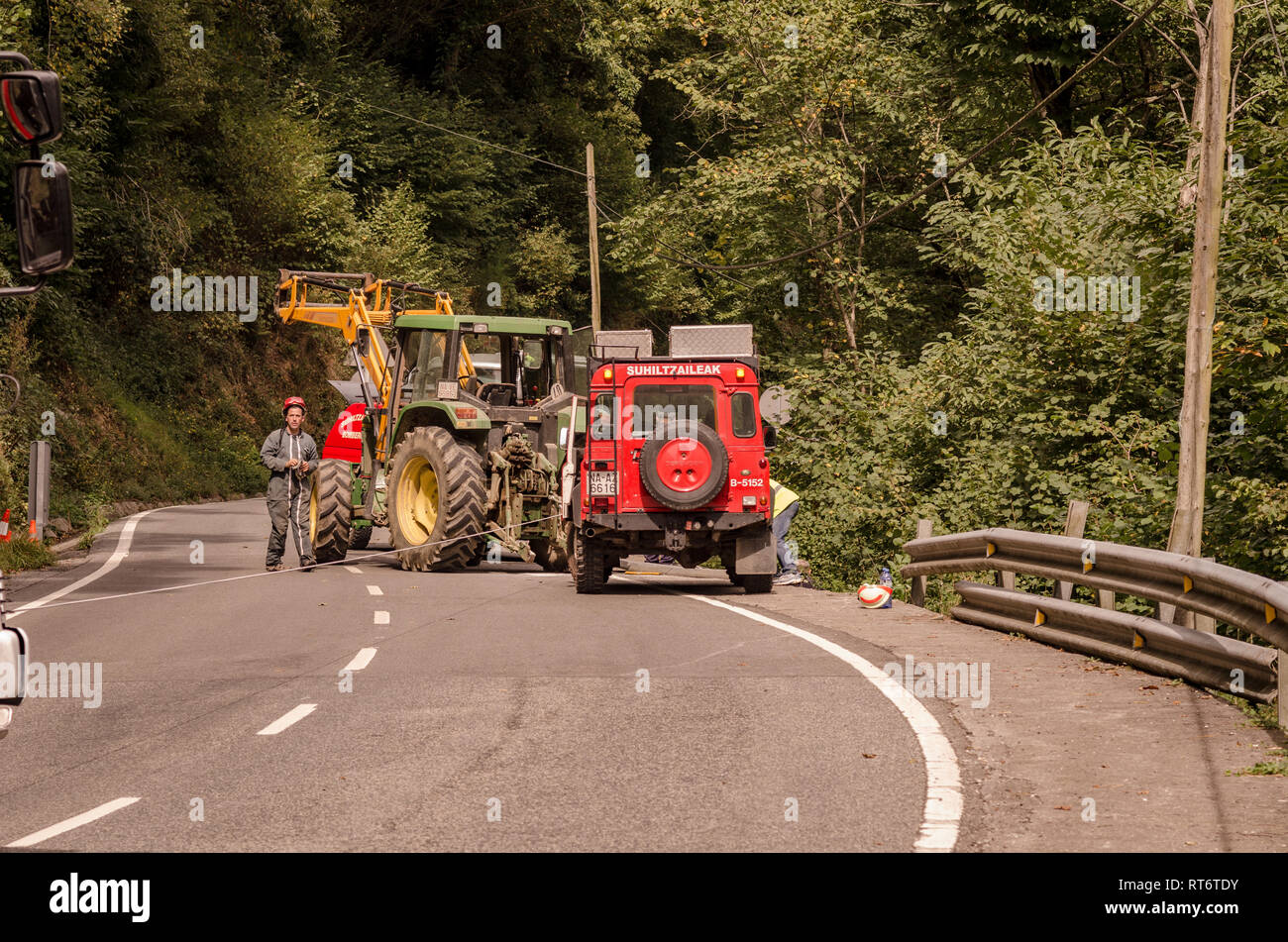Emergency services and tractor pulling a car out of a hires stock