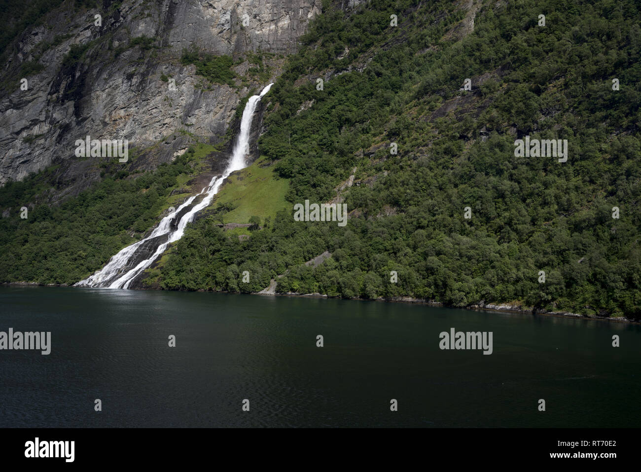 The Friar Waterfall faces the Seven Sisters waterfall just on the opposite site of Geirangerfjorden, which is a touristic hotspot in Norway. Stock Photo