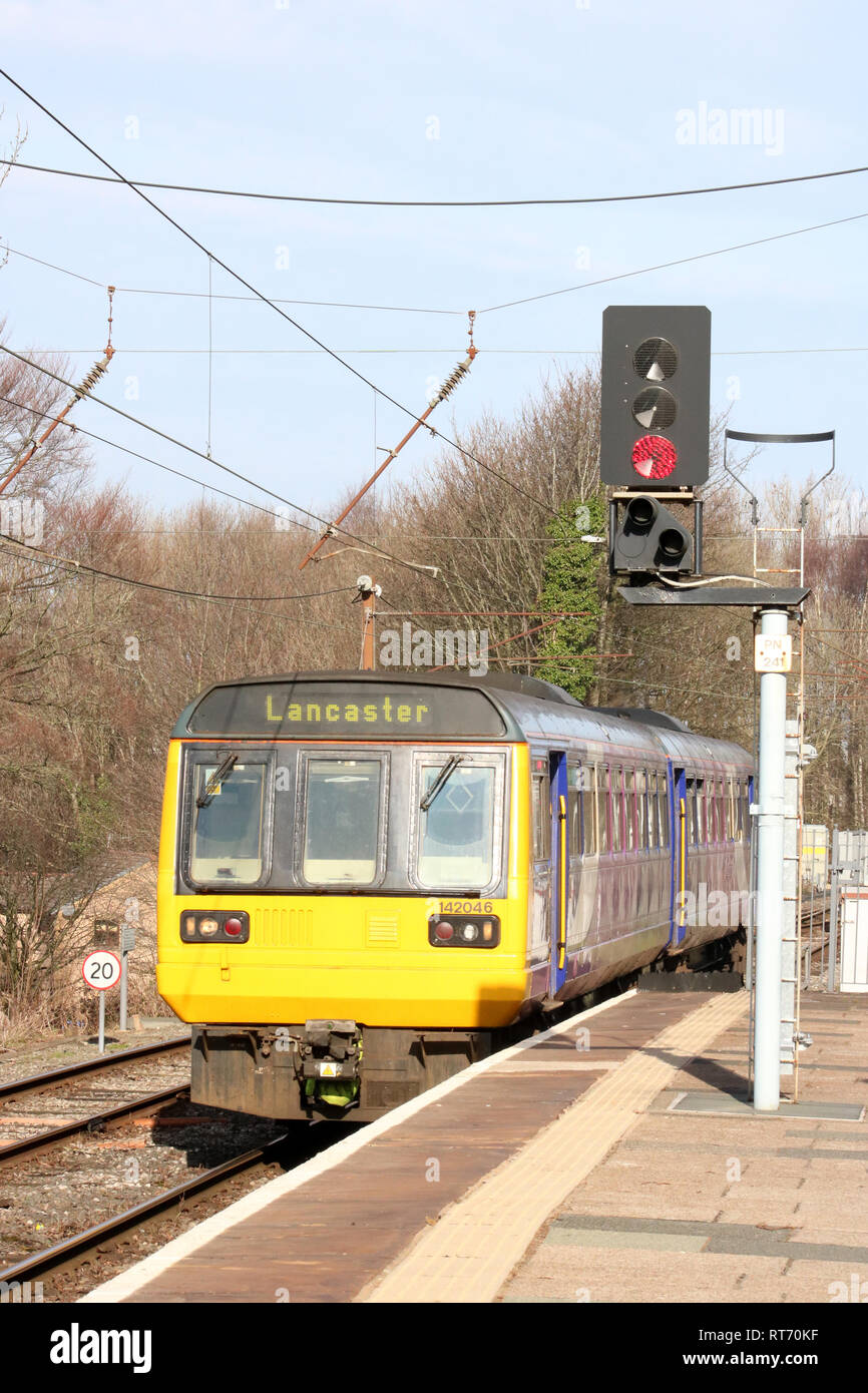 Class 142 Pacer diesel multiple unit, number 142 046, in Northern livery arriving at Lancaster railway station, platform 2, on 25th February 2019. Stock Photo