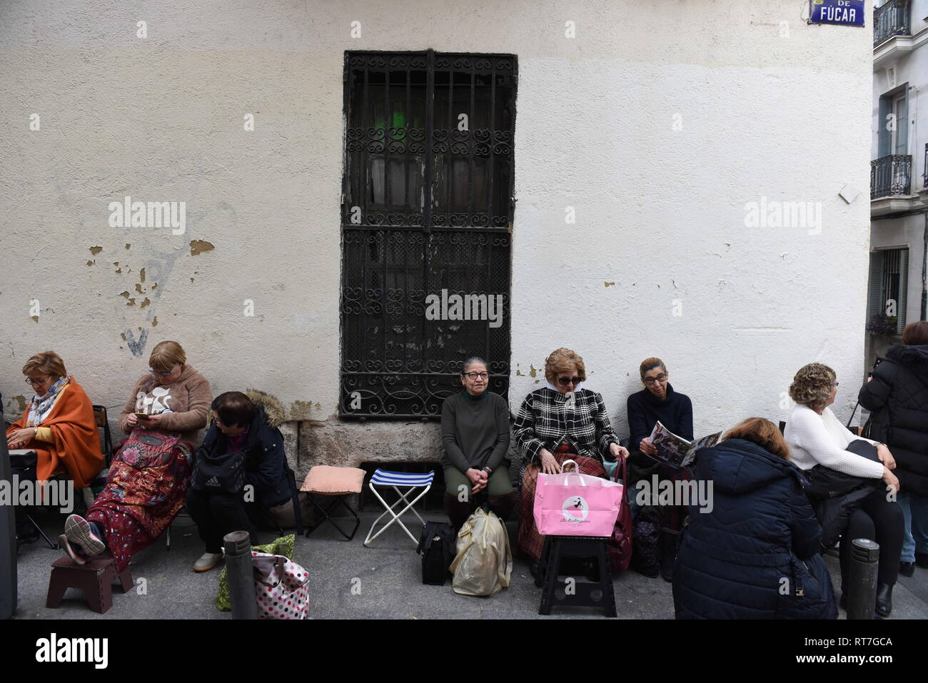 Madrid, Madrid, Spain. 28th Feb, 2019. Faithful followers seen waiting in queue in the street for the first Friday.Thousands of Catholics from various countries gathered close to the 'JesÃºs de Medinaceli' church in Madrid on the first Friday of March, Friday of Lent, to kiss the right foot of a 17th-century wooden image of Christ, known as Christ of Medinaceli. Pilgrims make three wishes to Jesus, of which he is said to grant one. Credit: John Milner/SOPA Images/ZUMA Wire/Alamy Live News Stock Photo